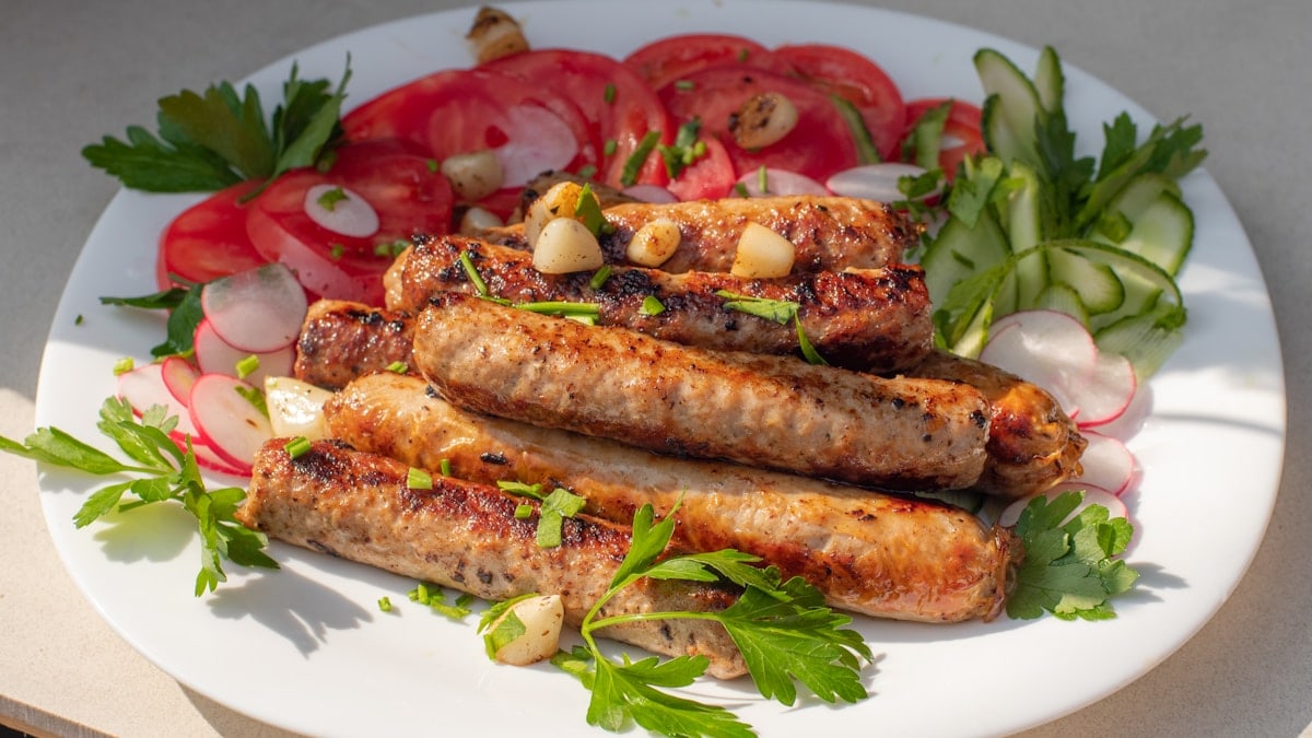 a white plate topped with meat and vegetables